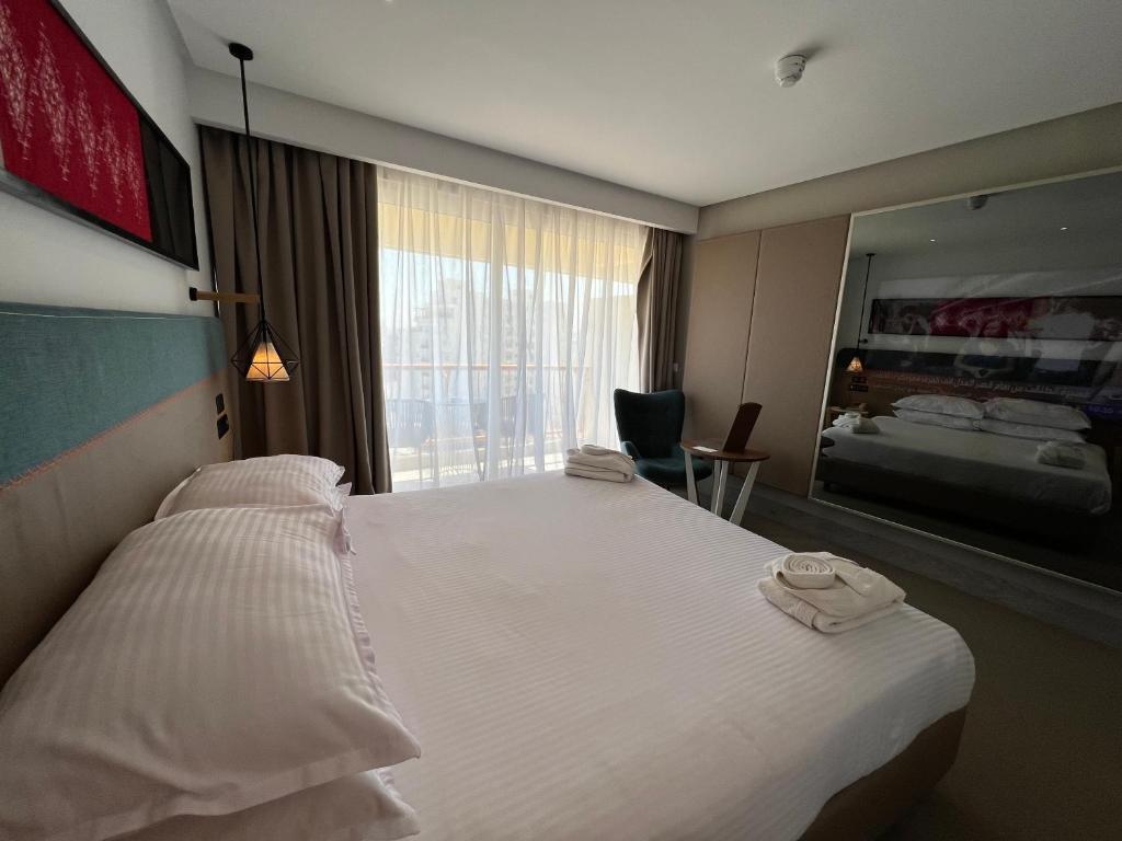 Sousse Pearl Marriott Resort & Spaにあるベッド