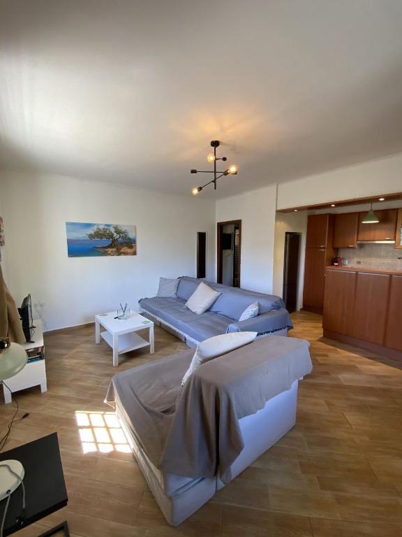 a bedroom with two beds and a couch at PATIMA Chalandri House in Athens