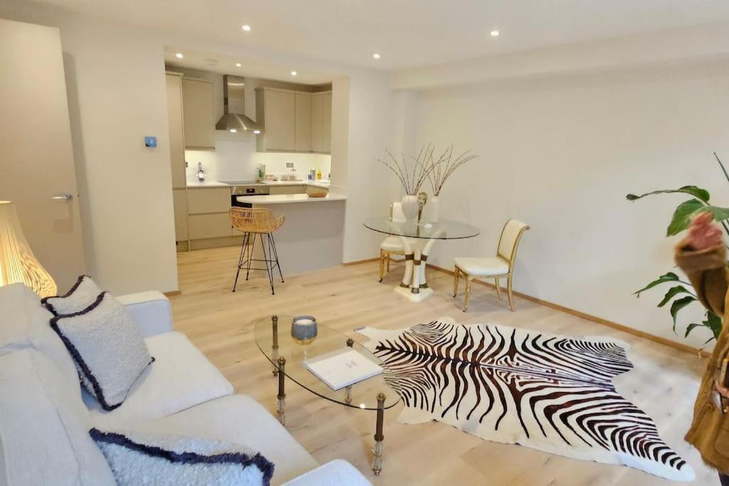 a living room with a zebra rug on the floor at Stylish new 2 bedroom apartment in London
