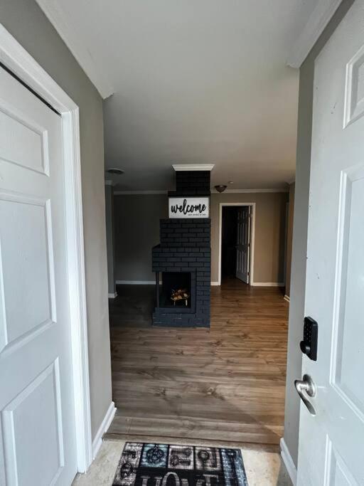a hallway with a fireplace in a house at Modern 3 Bedroom Ranch House in Newark