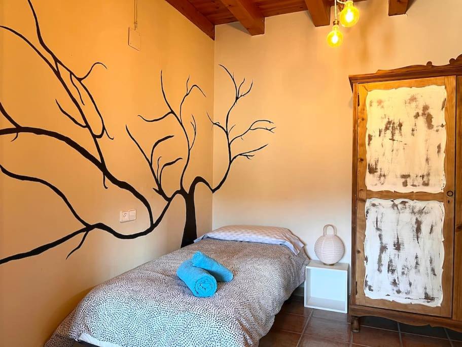 Cama o camas de una habitación en Casa Rural Martinach - L'Amfitriona
