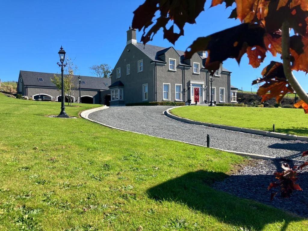 a large house with a winding road in front at Gelilah House in Loughbrickland