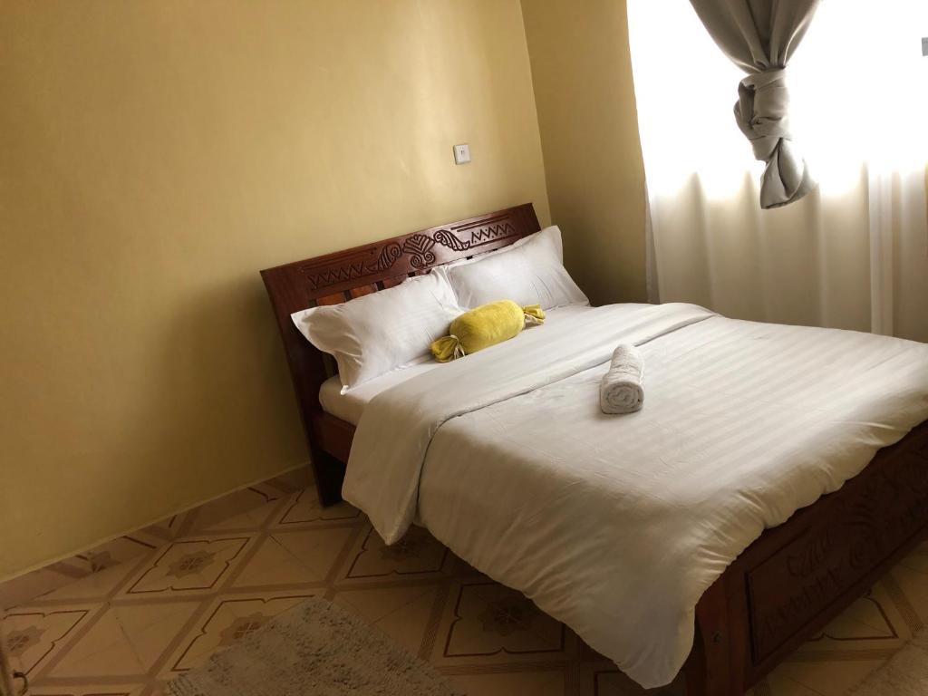 a bedroom with a bed with a stuffed animal on it at Mt zion penthouse in Lake View Estate