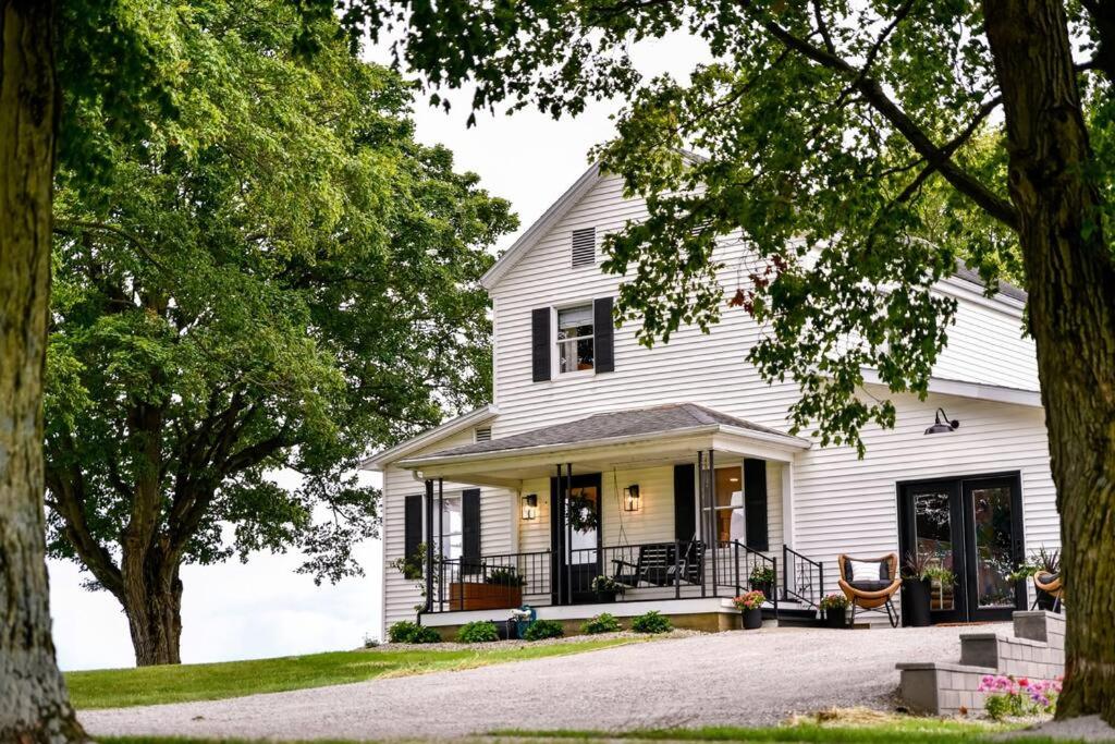 a white house with black shutters at The Bidwell Bungalow in Amanda