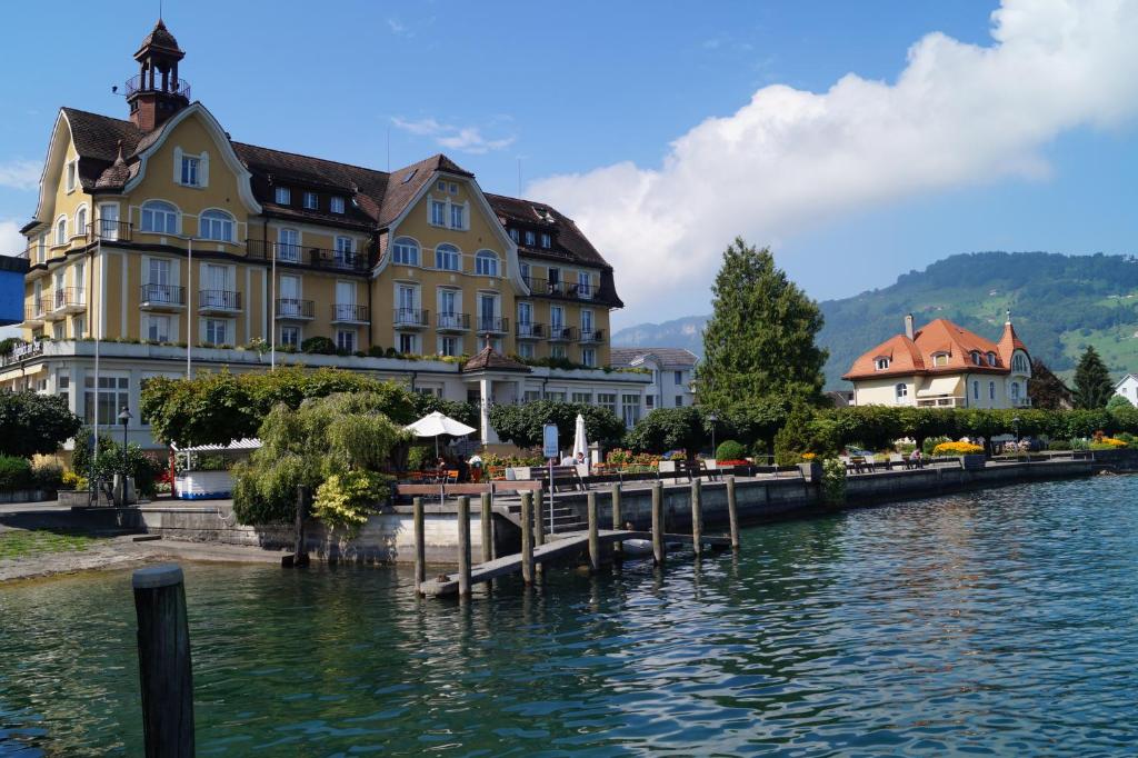 a large building next to a body of water at Rigiblick am See in Buochs