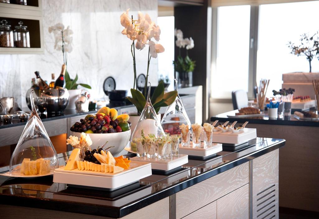 a buffet line with appetizers and fruit and snacks at The Marmara Taksim in Istanbul