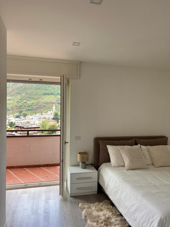 a bedroom with a bed and a large window at Bernina View in Tirano