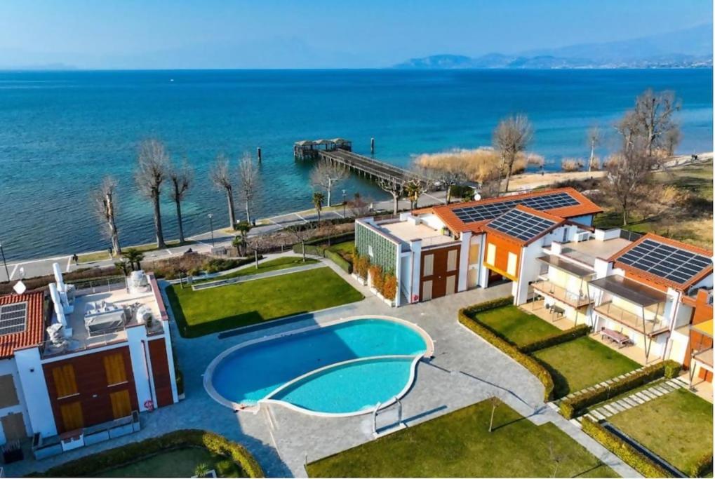 an aerial view of a house with a swimming pool at GardalandLuxuryApartment Pool & Free Parking in Ronchi