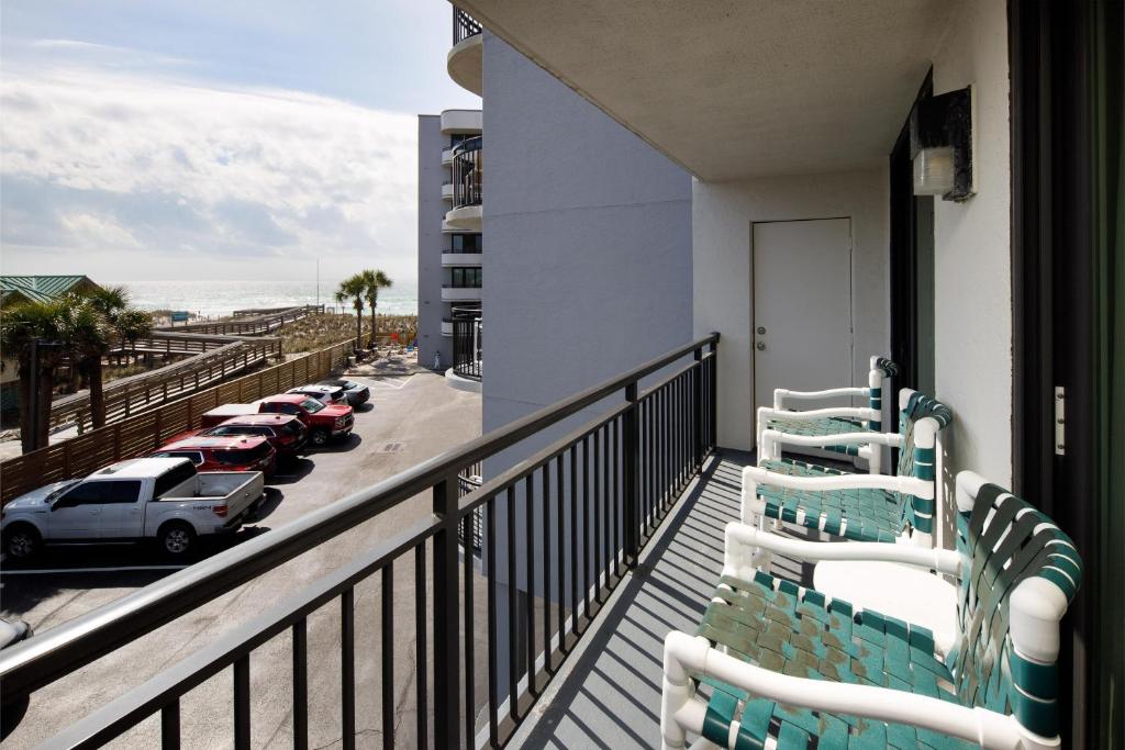 a balcony with chairs and a view of a parking lot at Nautilus Unit 2310 in Fort Walton Beach