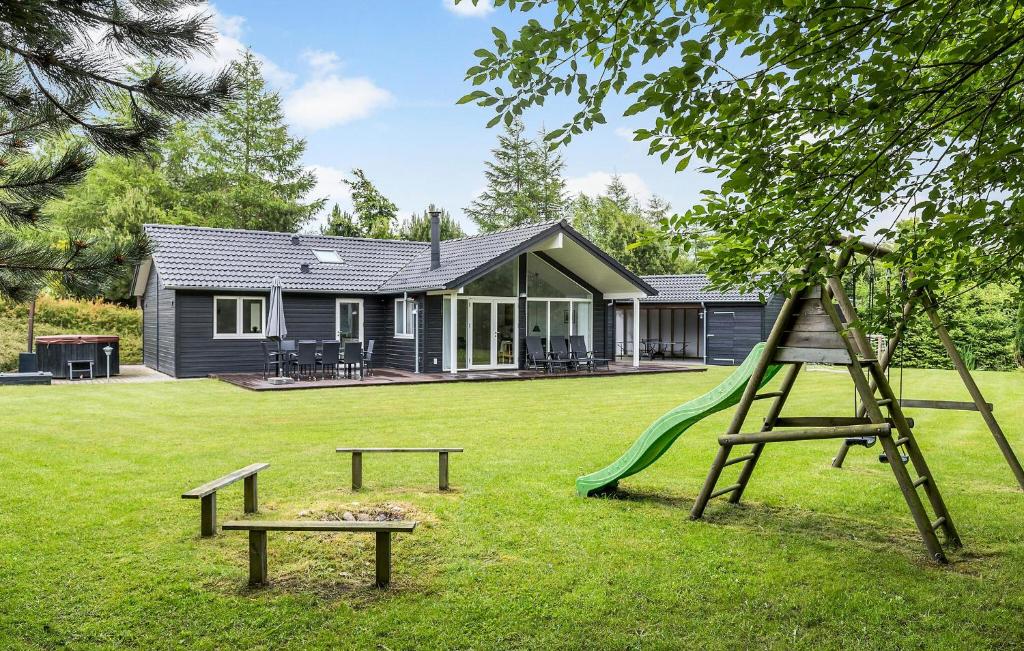 a playground with a slide and a house at Awesome Home In Glesborg With Sauna in Glesborg