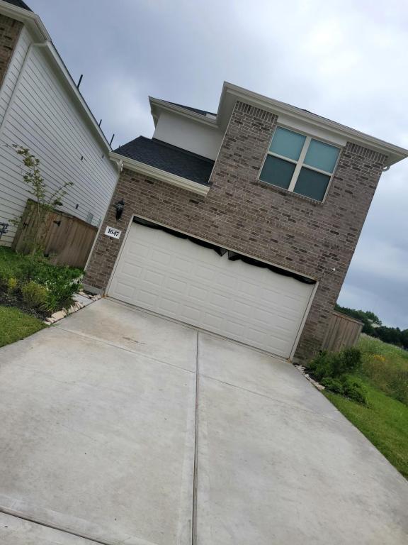 a house with a garage door in the driveway at Ts3 Houston in Missouri City