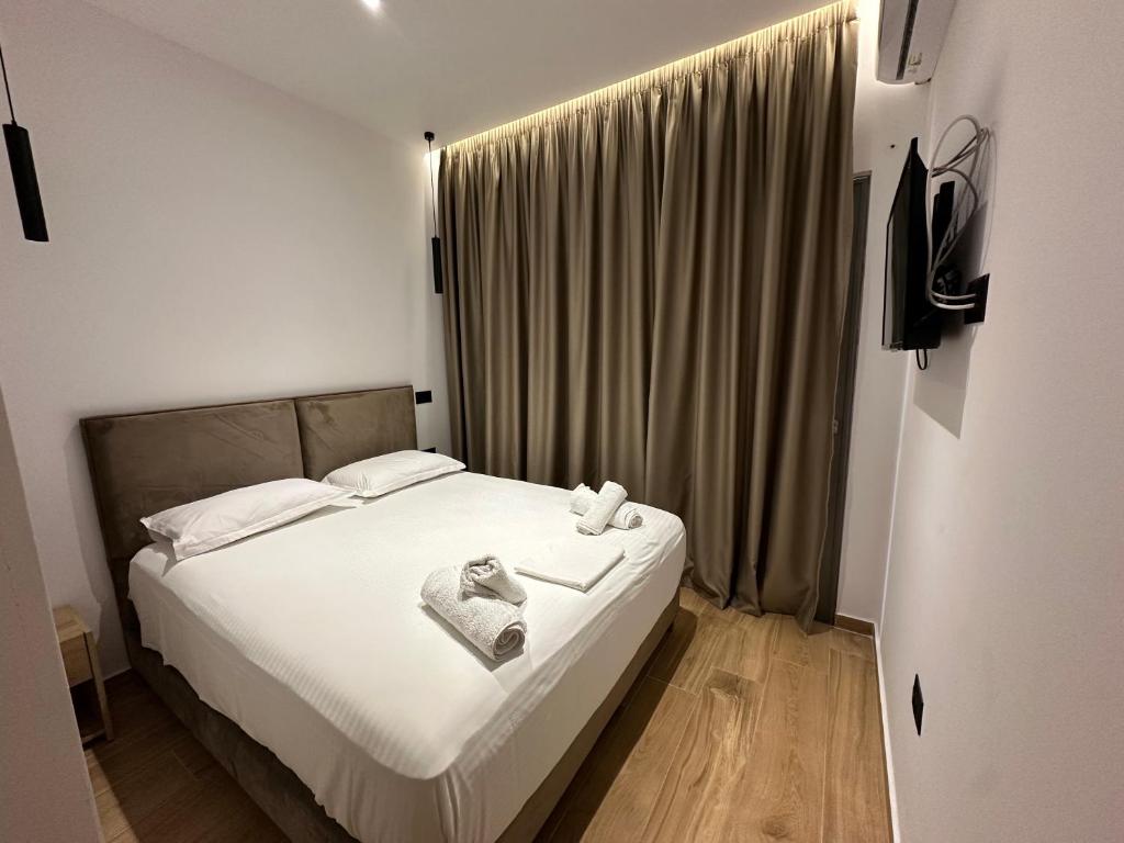 Postel nebo postele na pokoji v ubytování Suites Kozi
