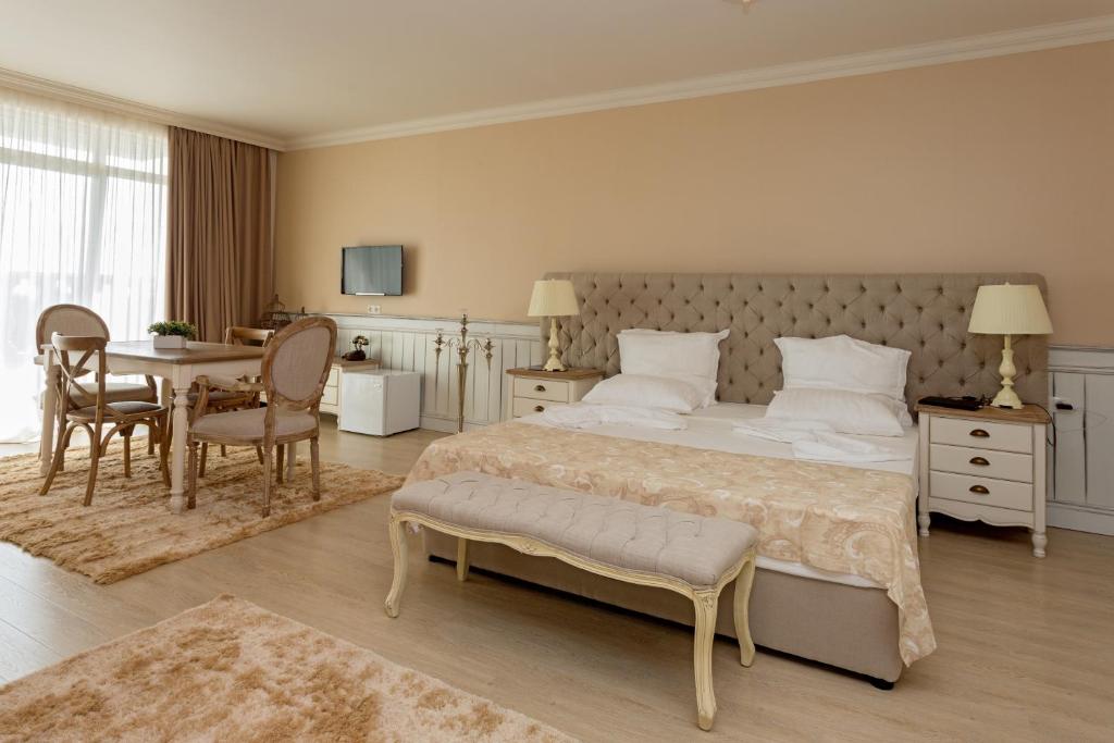 A bed or beds in a room at Therma Palace - All inclusive & Private Beach & Free Parking