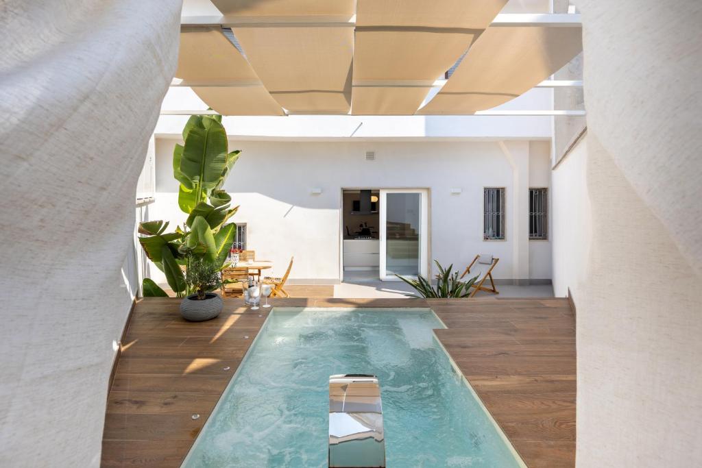 a swimming pool in the middle of a living room at Miro Luxury Home in San Vito dei Normanni