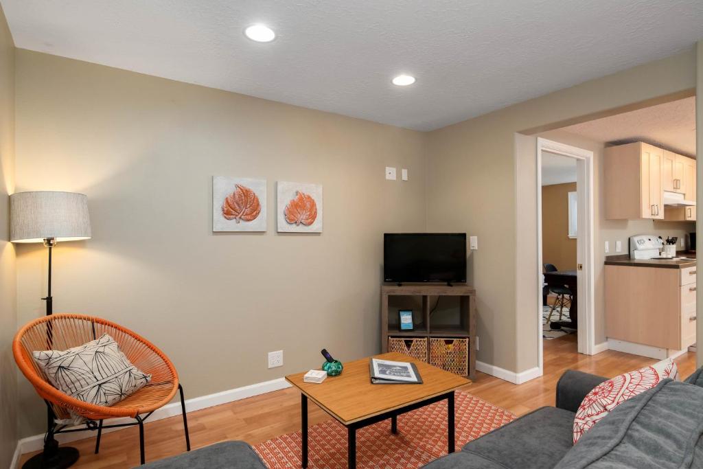 a living room with a couch and a table at #StayinMyDistrict St Johns Forest Park Apt in Portland