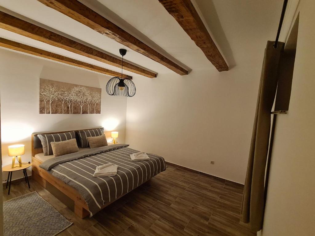 Postel nebo postele na pokoji v ubytování Apartman Denis