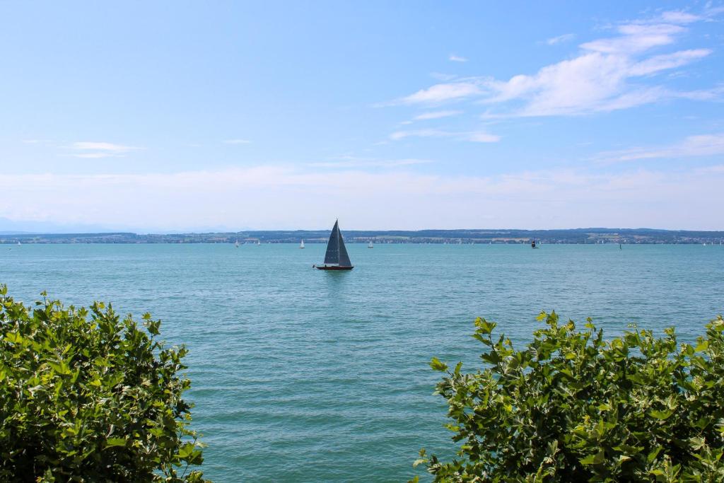 a sail boat in the middle of a large body of water at ZwoVier Meersburg in Meersburg