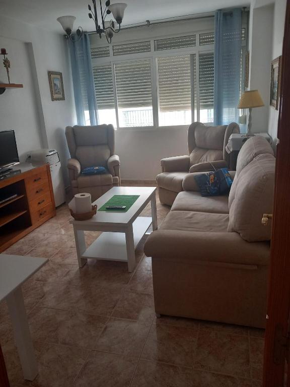 a living room with a couch and a coffee table at Villa Trini in Salobreña