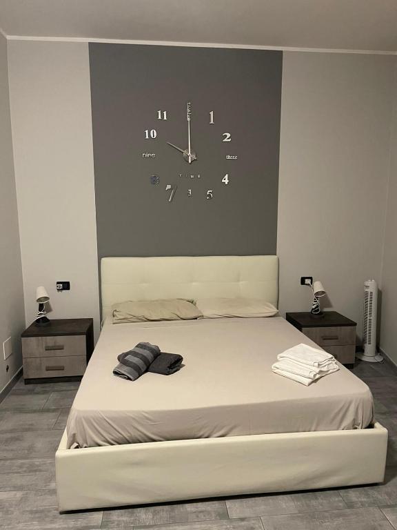 a bedroom with a bed with a clock on the wall at b&b da Patrizia in Turin