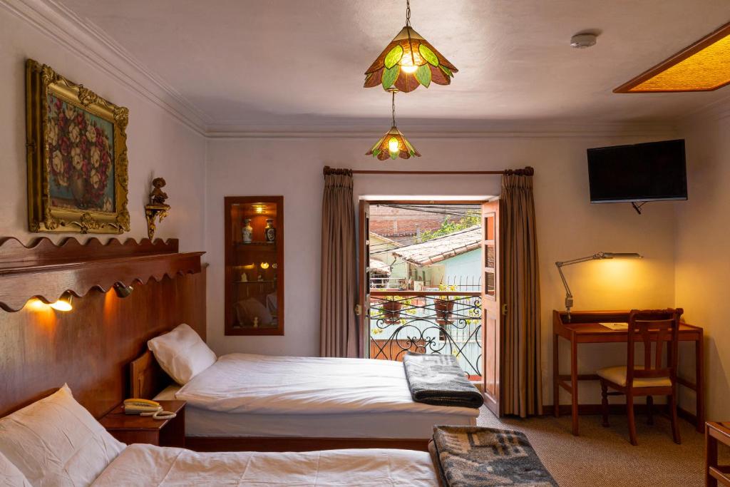 Voodi või voodid majutusasutuse Hotel La Posada de Atahualpa toas