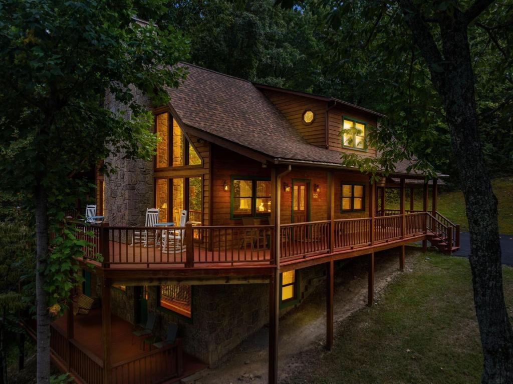 a house with a wrap around deck at night at Restoration Retreat at Greenbrier cabin in Sevierville