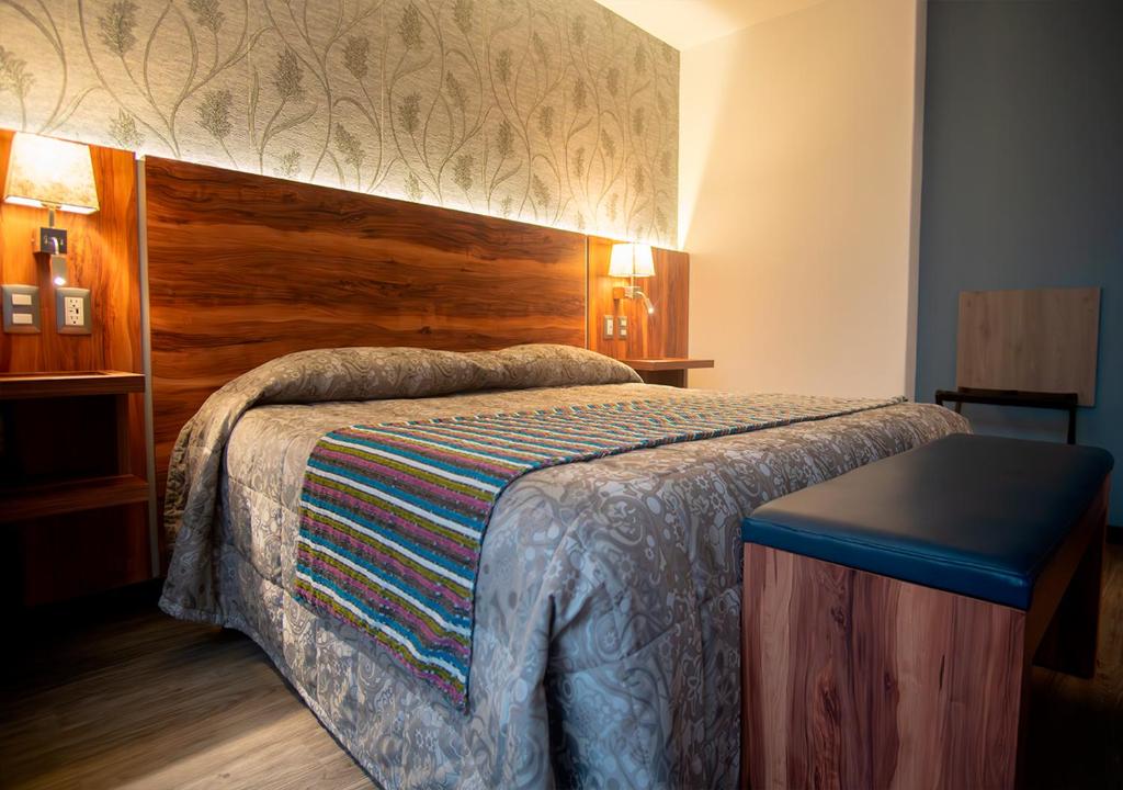 Postel nebo postele na pokoji v ubytování Hotel Parque Satelite