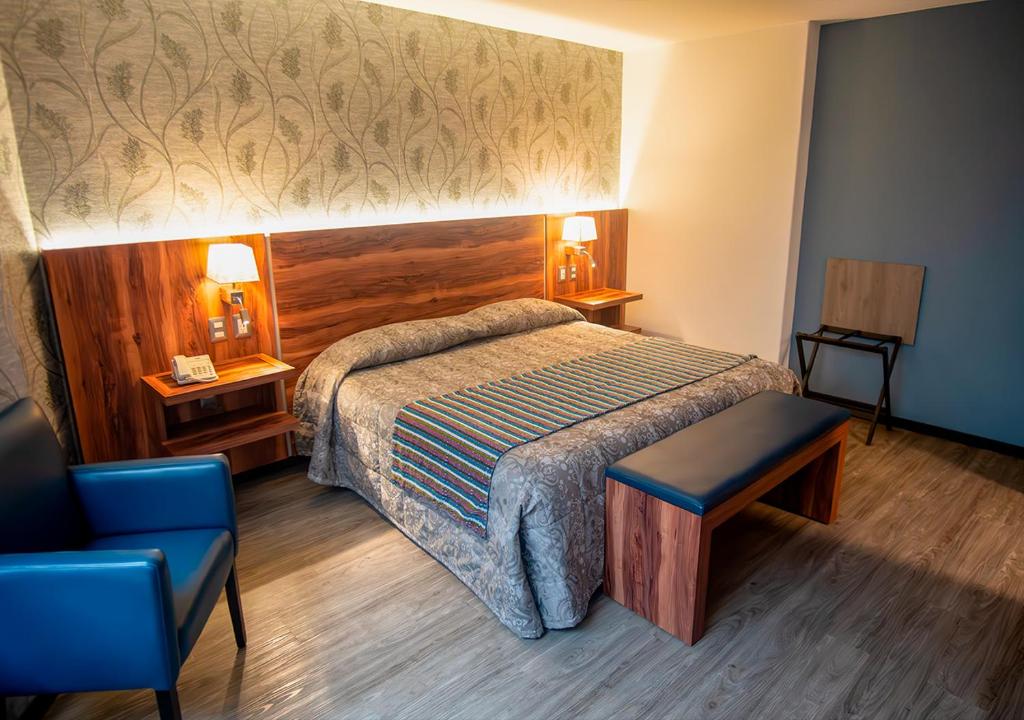 Postel nebo postele na pokoji v ubytování Hotel Parque Satelite