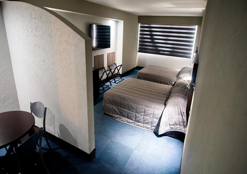 Postel nebo postele na pokoji v ubytování Hotel Parque Satelite