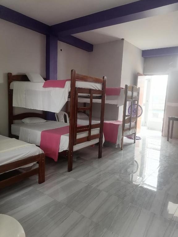Postel nebo postele na pokoji v ubytování Ayahuasca Hostel