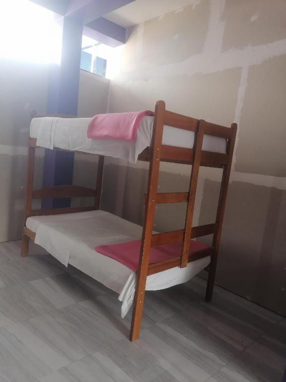 Postel nebo postele na pokoji v ubytování Ayahuasca Hostel