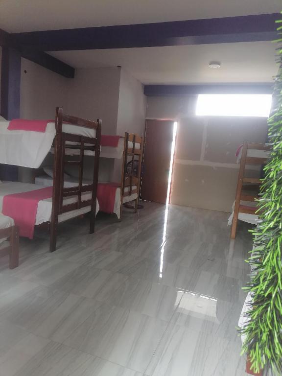 Postel nebo postele na pokoji v ubytování Ayahuasca Hostel