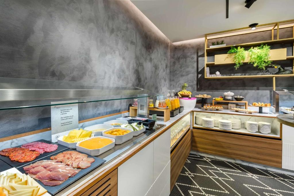 a buffet line with different types of food at Occidental Alicante in Alicante