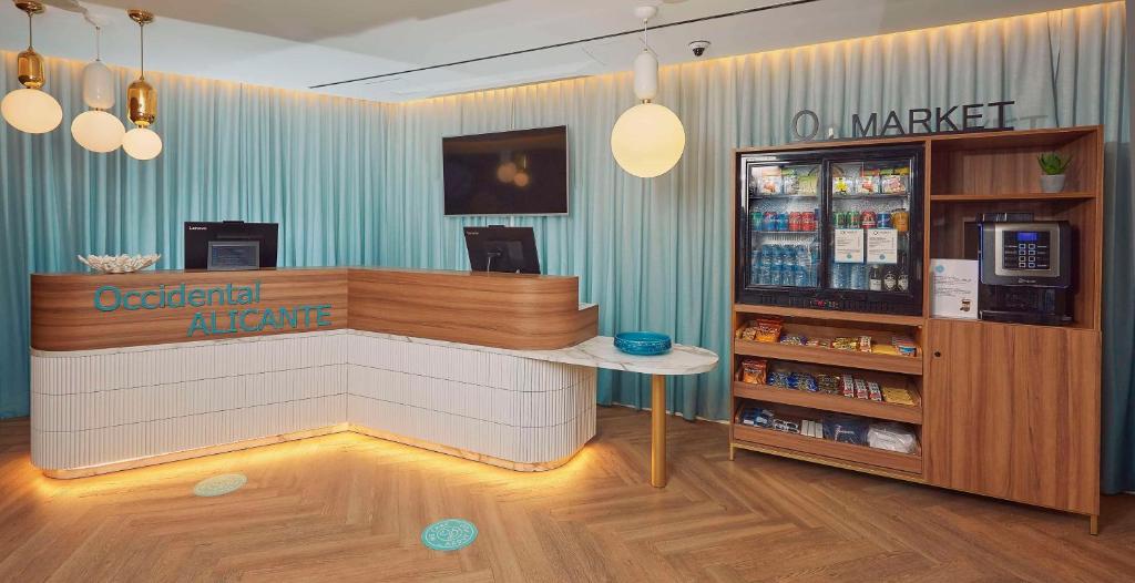 a counter in a store with a drink cooler at Occidental Alicante in Alicante