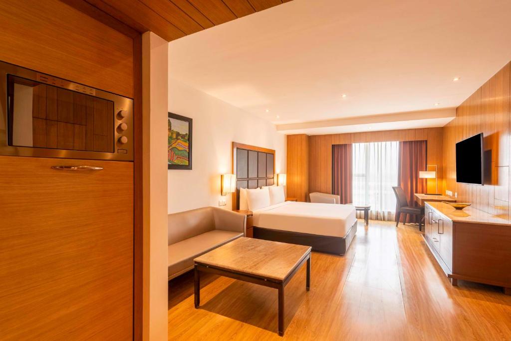 a hotel room with a bed and a couch at Svelte Delhi, a member of Radisson Individuals in New Delhi