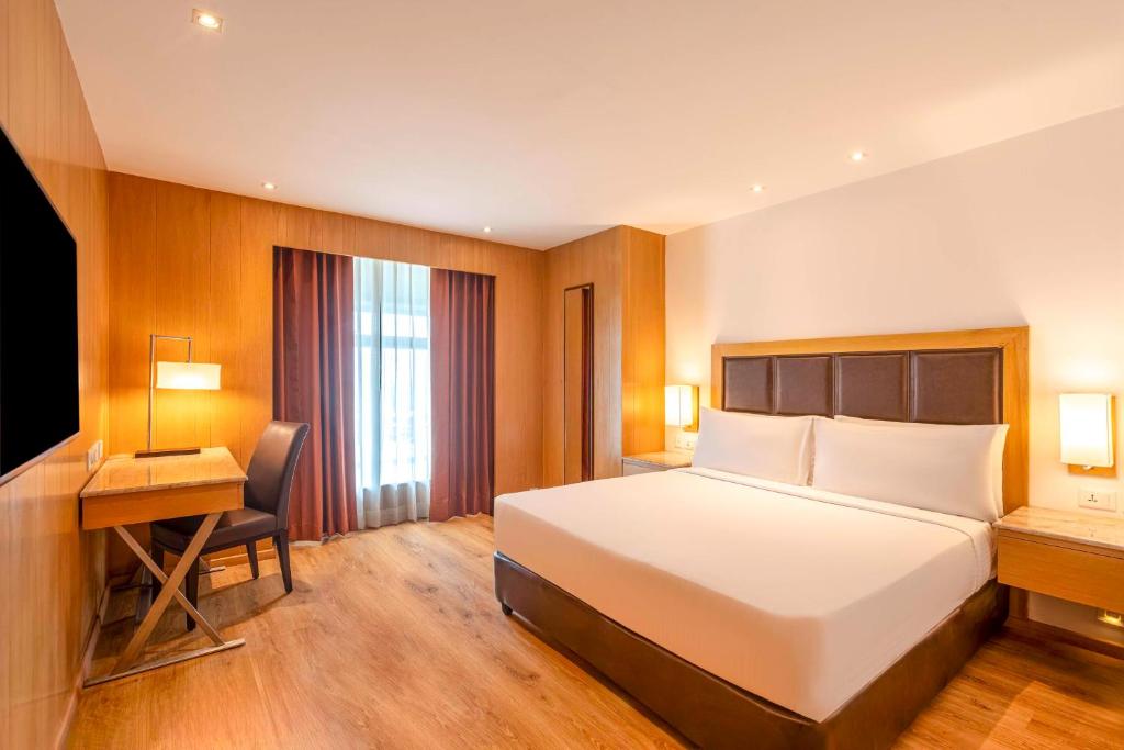a hotel room with a bed and a desk at Svelte Delhi, a member of Radisson Individuals in New Delhi