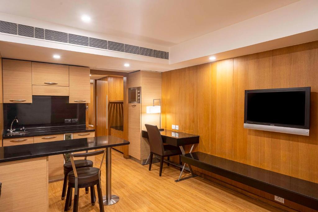 a hotel room with a flat screen tv on the wall at Svelte Delhi, a member of Radisson Individuals in New Delhi