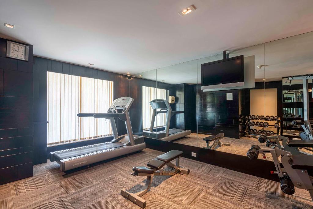 a gym with a treadmill and a mirror at Svelte Delhi, a member of Radisson Individuals in New Delhi