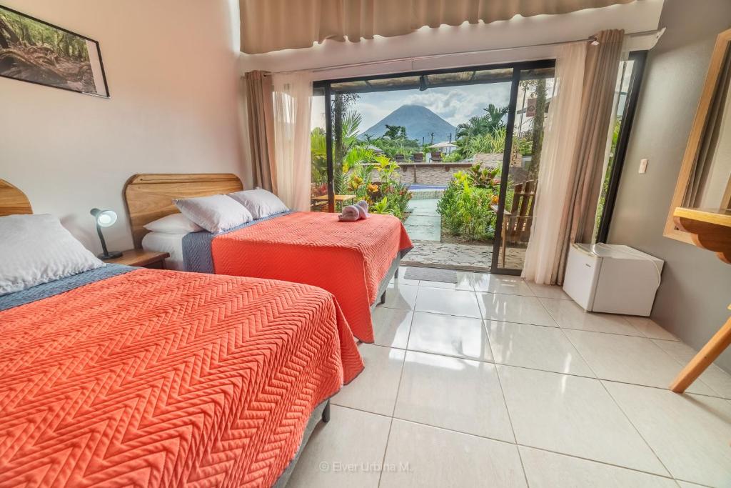 Postel nebo postele na pokoji v ubytování Hotel Secreto La Fortuna