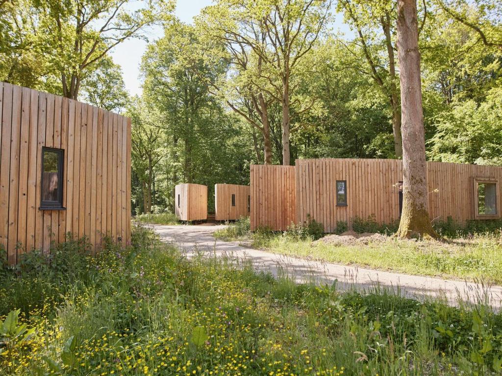 a row of wooden fences with trees in the background at Lakeside Lovely Stay, Antoing in Antoing
