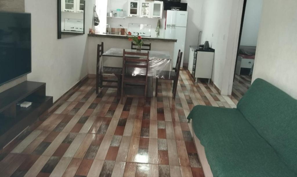 a living room with a table and a kitchen at Casa do Barney Enseada Guaruja in Ilha de Santo Amaro