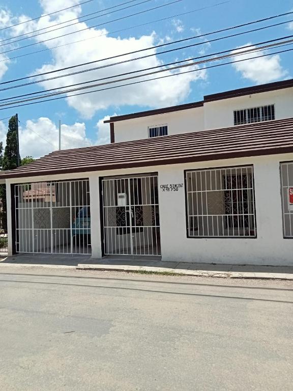 a white building with barred windows on a street at San Bernardino 2 in Valladolid