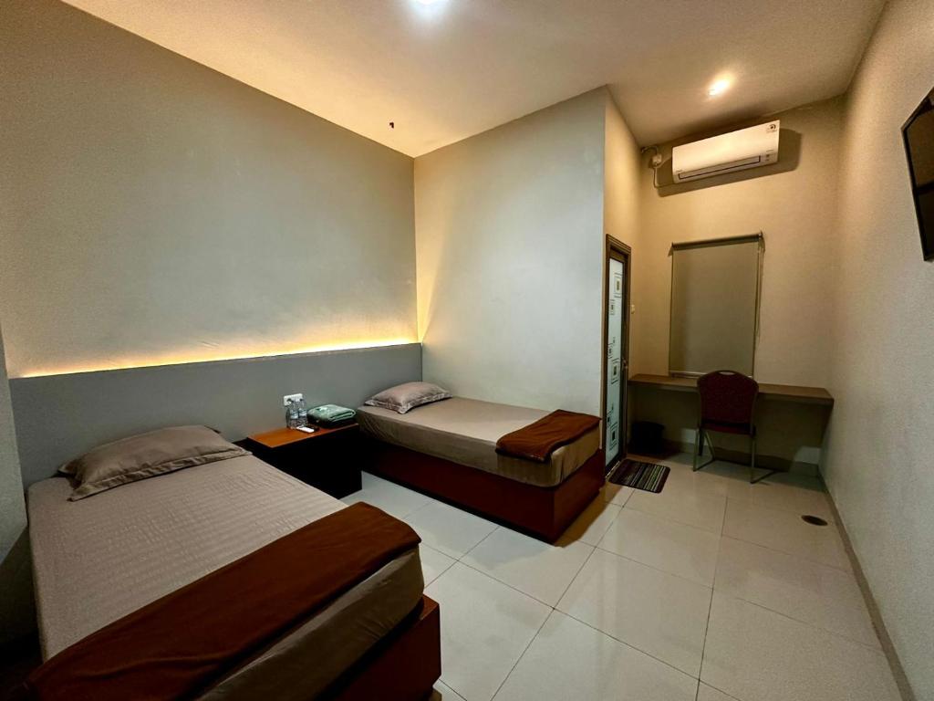 Postel nebo postele na pokoji v ubytování Grands Orchid Hotel