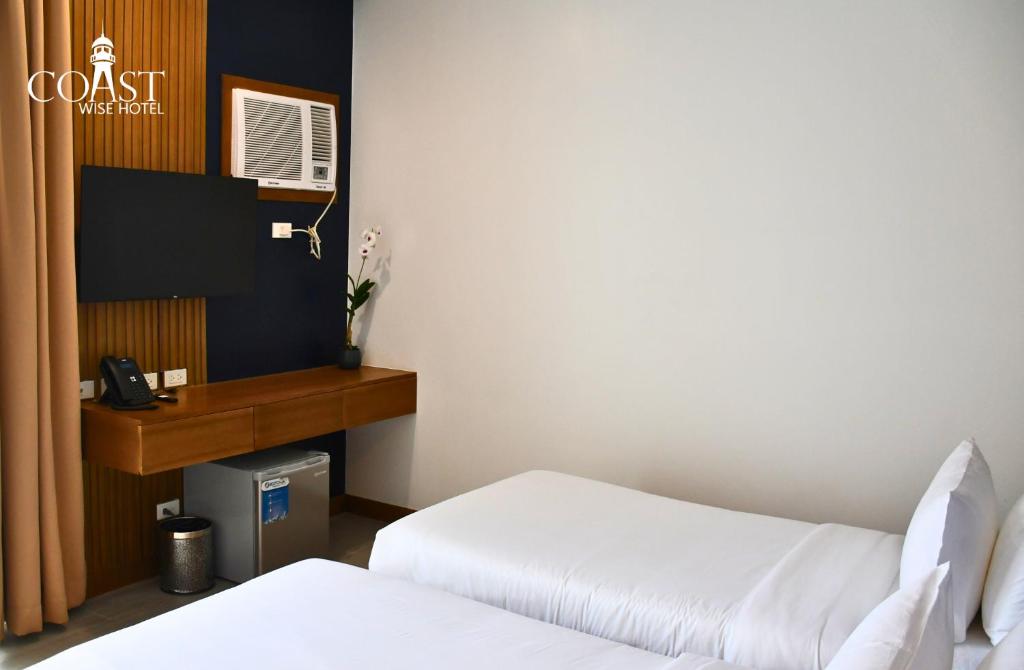 Postel nebo postele na pokoji v ubytování Coast Wise Hotel Dumaguete