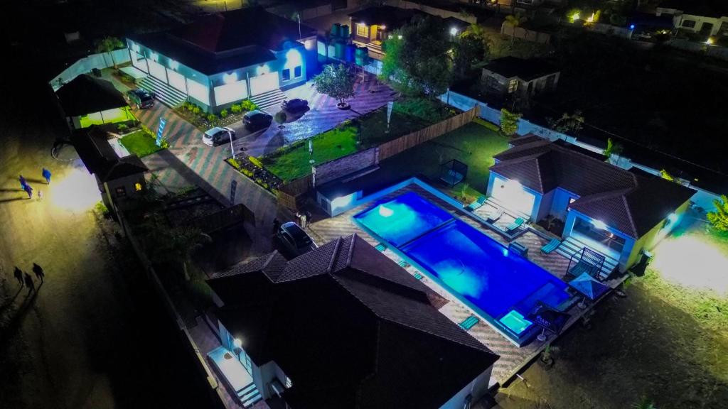 an overhead view of a house with a swimming pool at night at Mercy Boutique Hotel in Thohoyandou