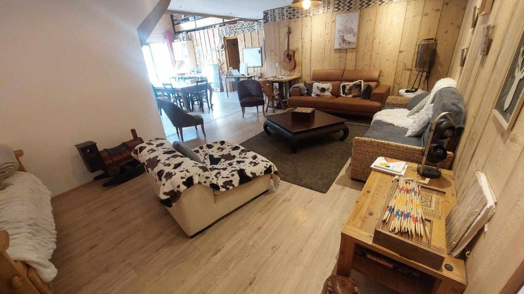 a living room with a couch and a table at Yourtes Olachat proche Annecy in Faverges