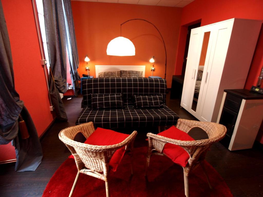 a bedroom with a bed and two chairs in it at Andres Guest house Sanremo in Sanremo