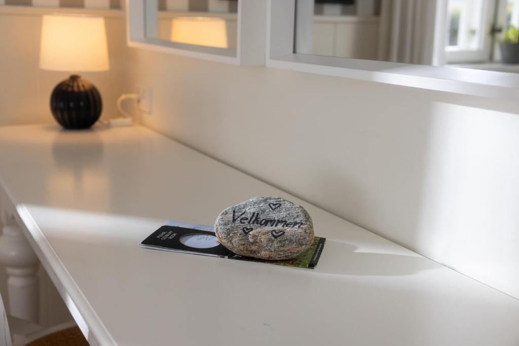 a rock sitting on a white counter in a room at Gl. Avernæs Sinatur Hotel & Konference in Ebberup