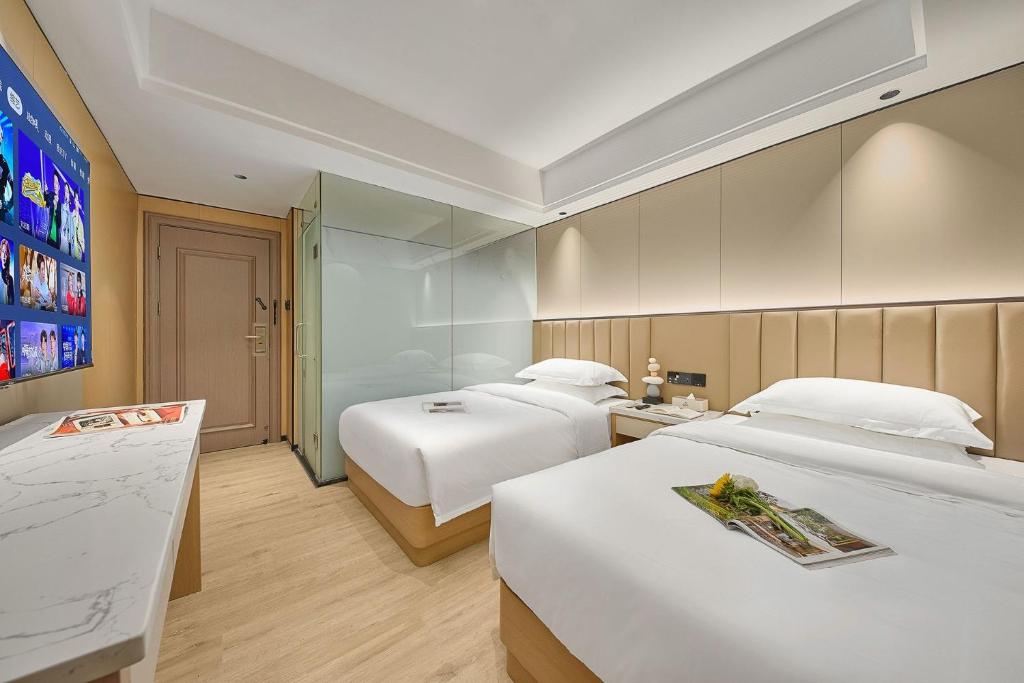 Postel nebo postele na pokoji v ubytování Meiye Hotel Zhujiang Newtown - Wuyangcun Metro - Canton Fair