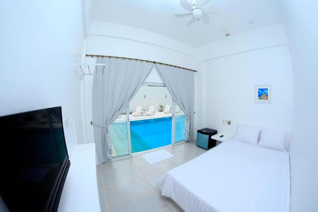 Postel nebo postele na pokoji v ubytování Coron Bluewave Hotel
