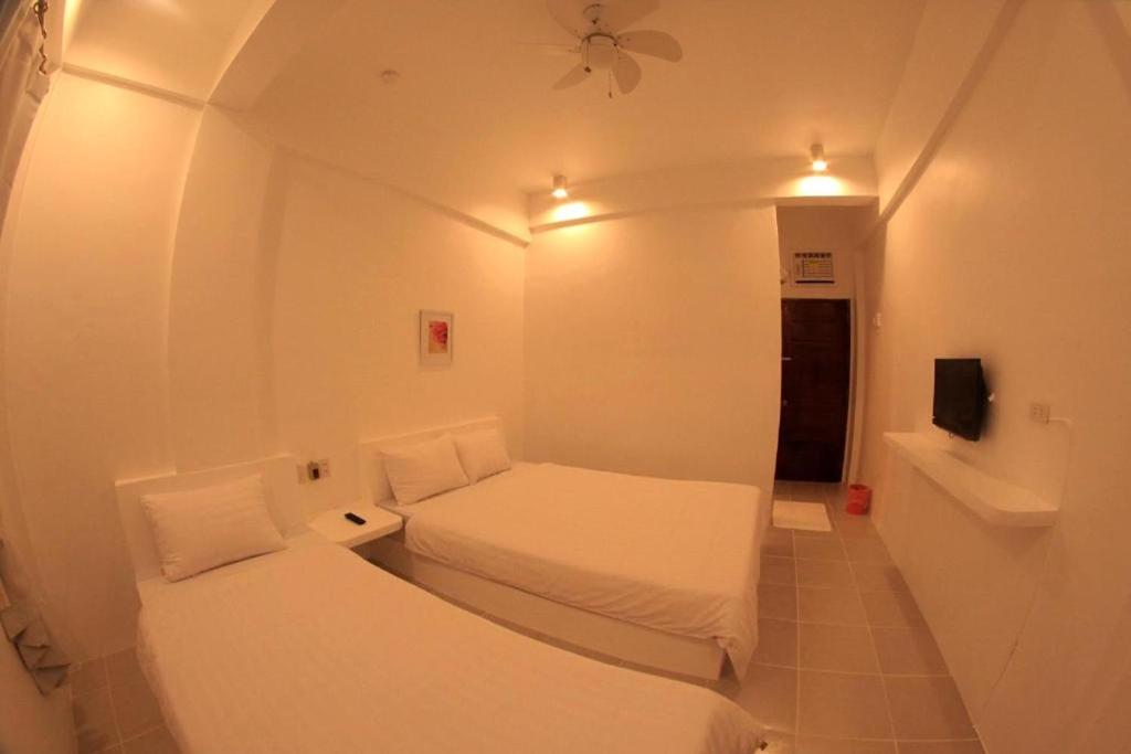 Postel nebo postele na pokoji v ubytování Coron Bluewave Hotel